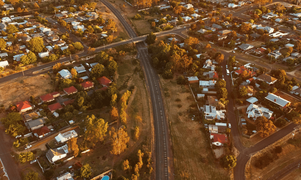 Aerial view of a suburban neighborhood with houses and trees during autumn.